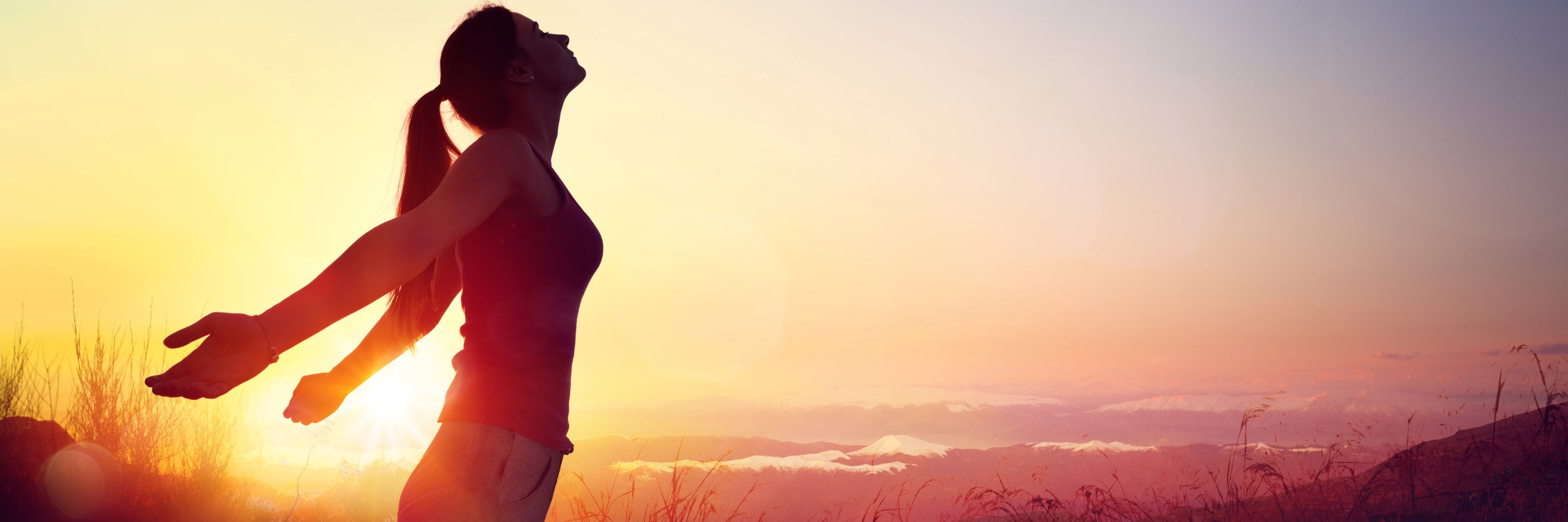 Happy health woman thriving in an evening sunset. Headley Holistics Overall Health & Wellness Supplements