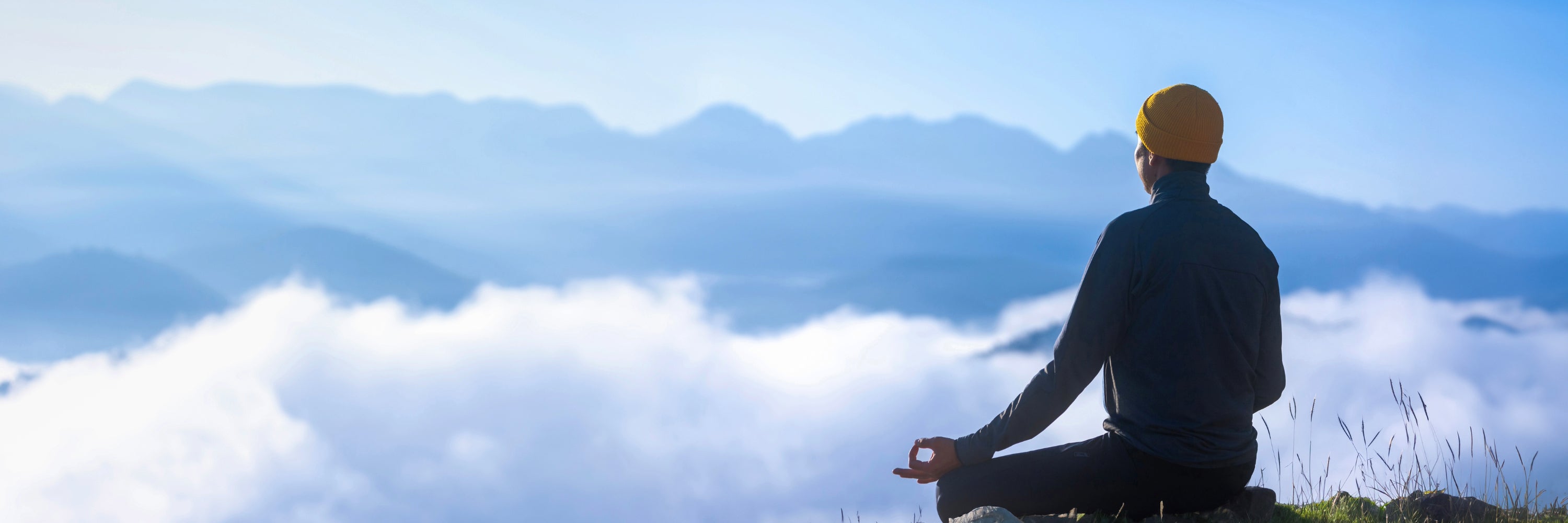 Man sitting, meditating on a cliff. Mind and Mood Supplement, Best Kava Supplement
