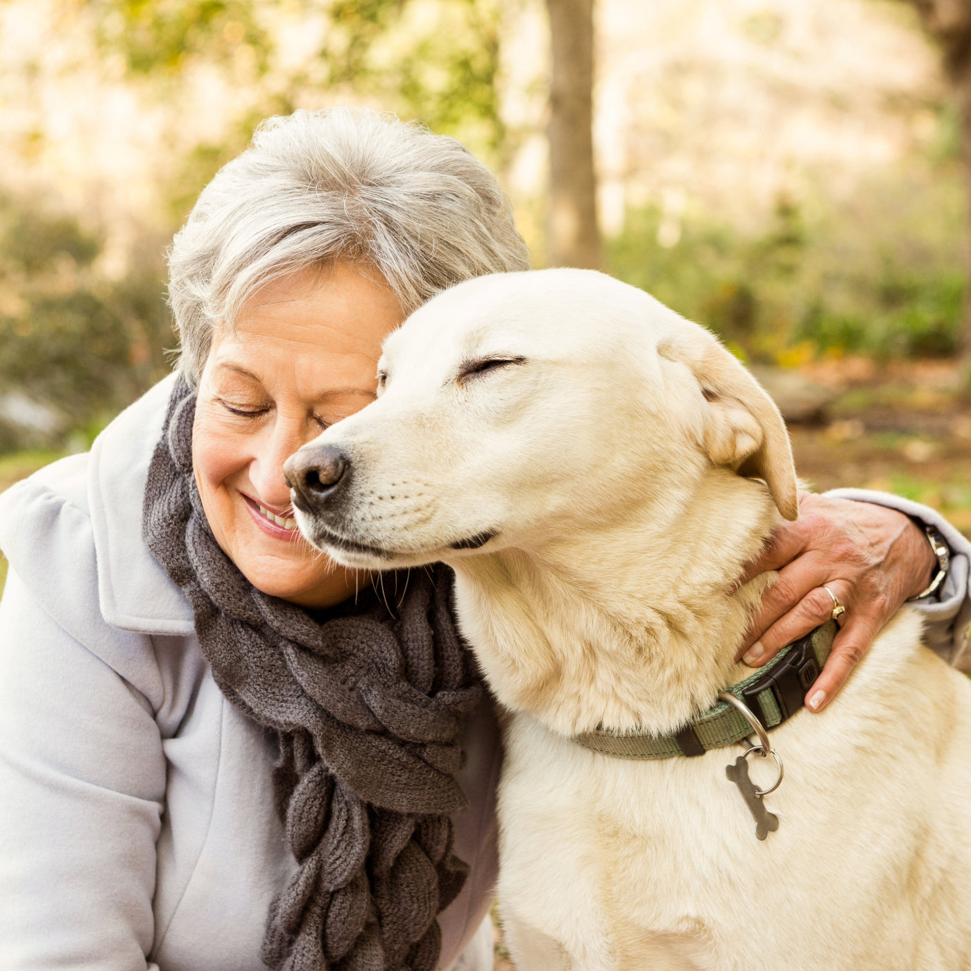 Woman and her dog enjoying the afternoon because K9 Nom-Nom nuggets for dogs helps keep her dog calm and happy plus these treats work as a natural flea repellent