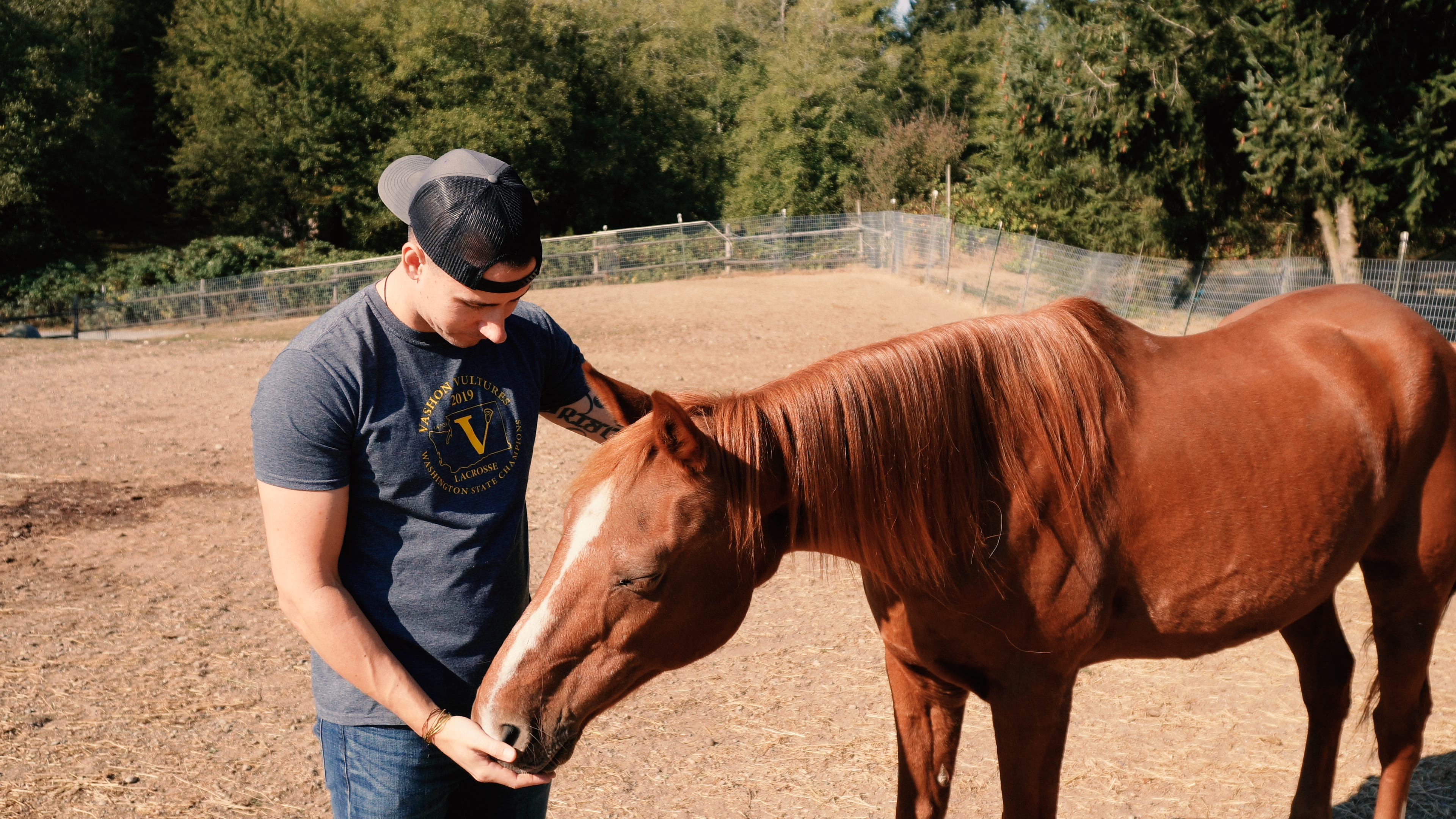 Headley Holistics Co-Founder, Tristan, Sharing a sweet and tender moment with one of the rescue horses on their farm, Ranger.