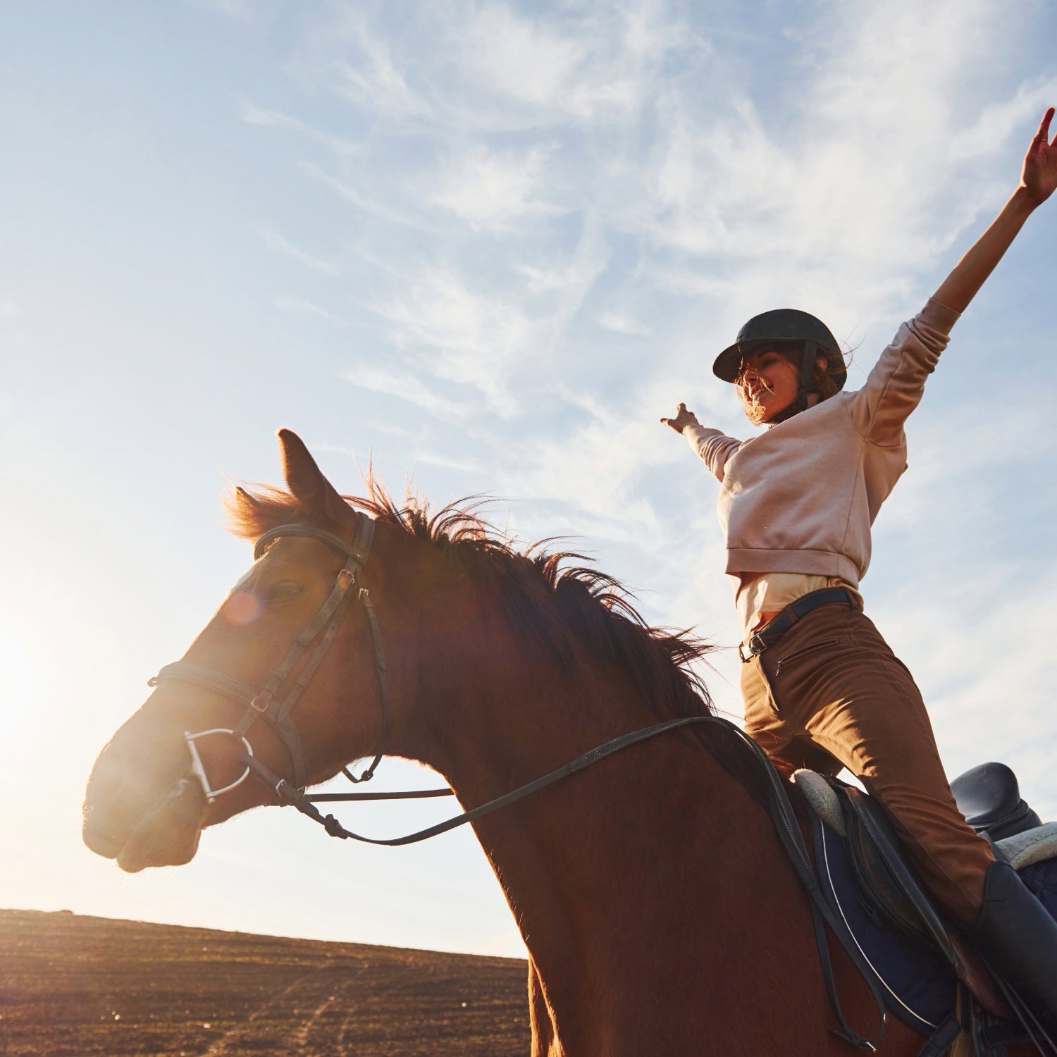 Happy and Healthy woman and her horse, celebrating how well Evolved Remedies products have helped them thrive.
